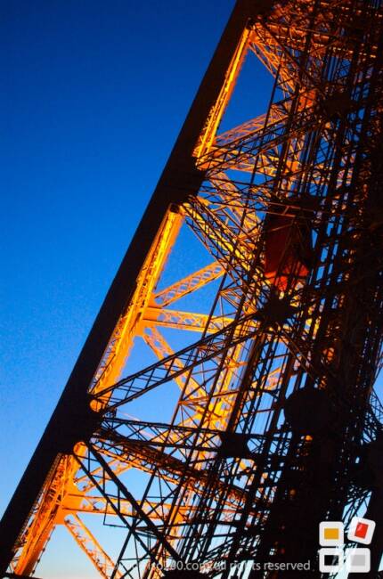 Internal lights light up the Eiffel Tower at sunset.