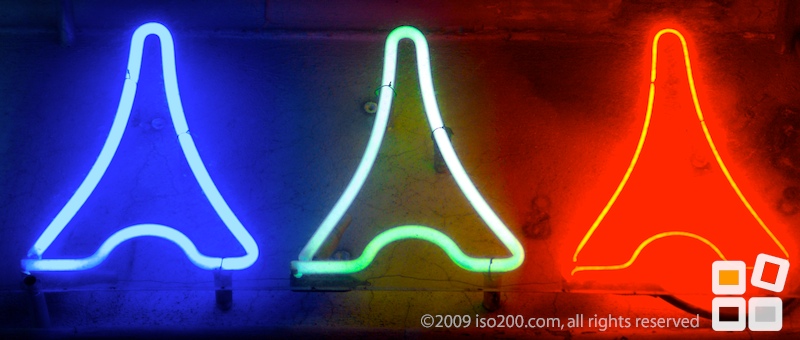 Three neon Eiffel Towers on a wall, Rue de la Paix, Paris, France