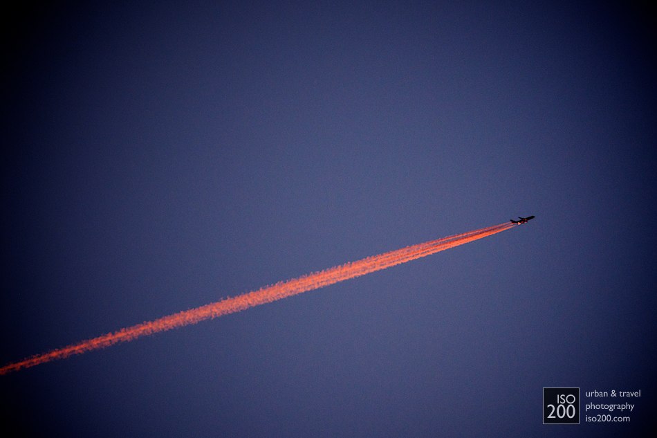 The last rays of sunset reflect off the contrail of a passenger jet aeroplane flying high above Hawick in the Scottish Borders.
