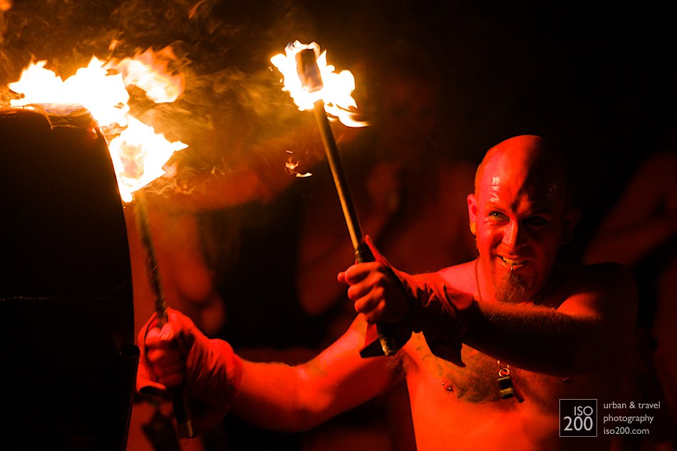 A red man with fire sticks beats a drum at the Edinburgh Beltane.