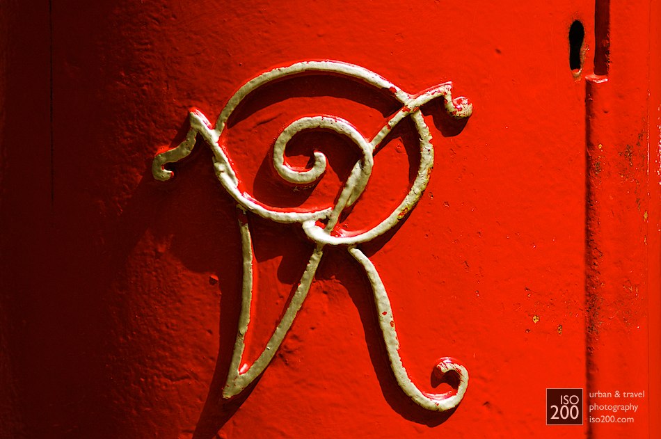 Queen Victoria's initials in gold on a red Royal Mail postbox, Sheffield, England