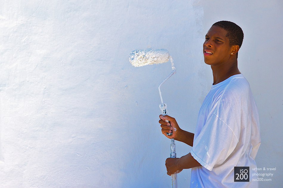 A painter holds a white roller as he paints the outside of Hamilton's City Hall, Bermuda