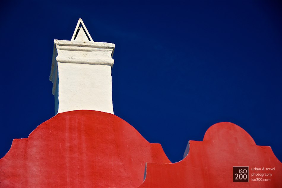 Big gable, little gable - a white chimney and coloured rounded gables on a building in Flatt's Village, Bermuda