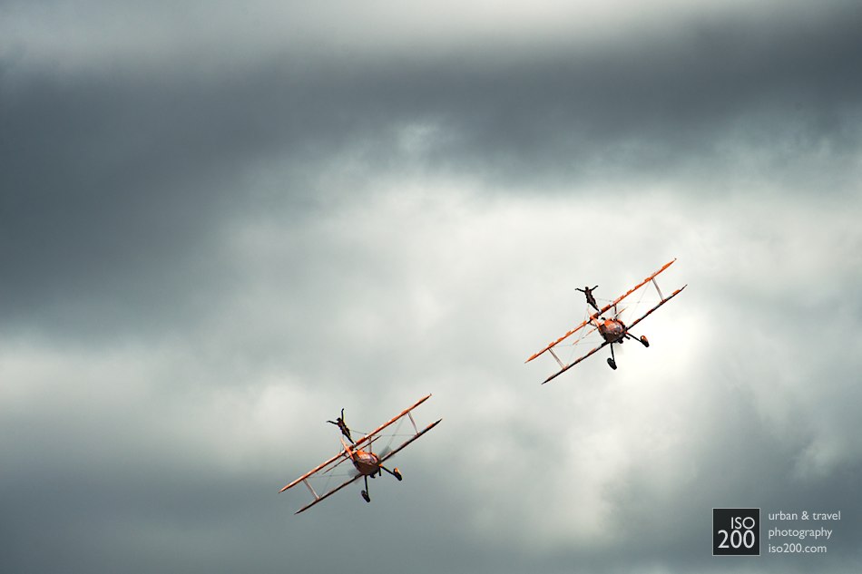 Two Breitling Wingwalkers from the AeroSuperBatics display team fly into the clouds at the 2011 East Fortune Museum of Flight Airshow.
