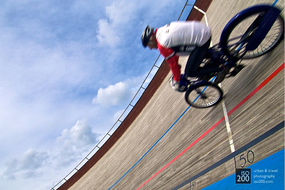 A pace motorcycle goes around a banked turn at the velodrome in Edinburgh.