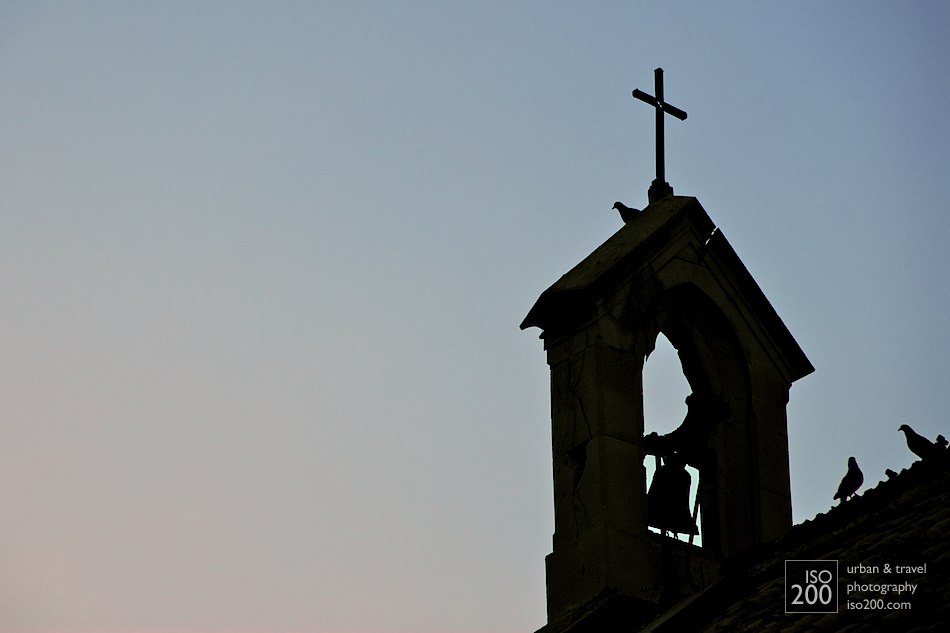 Bell tower of a Malaga church at dusk.
