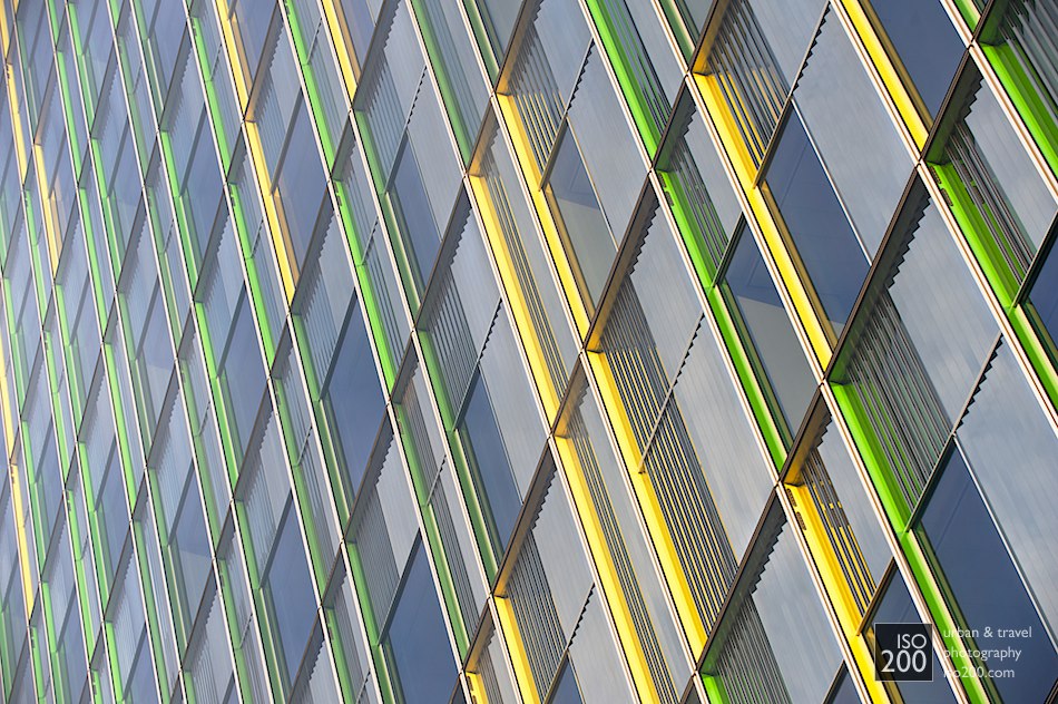 Multi-coloured window jambs on an office building in central Brussels. From head on the building looks fairly normal: its only when you look up and along the walls that the hidden colours become visible.