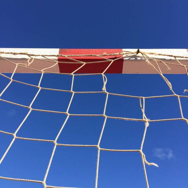 

Football goal and nets against a clear Spanish sky.
